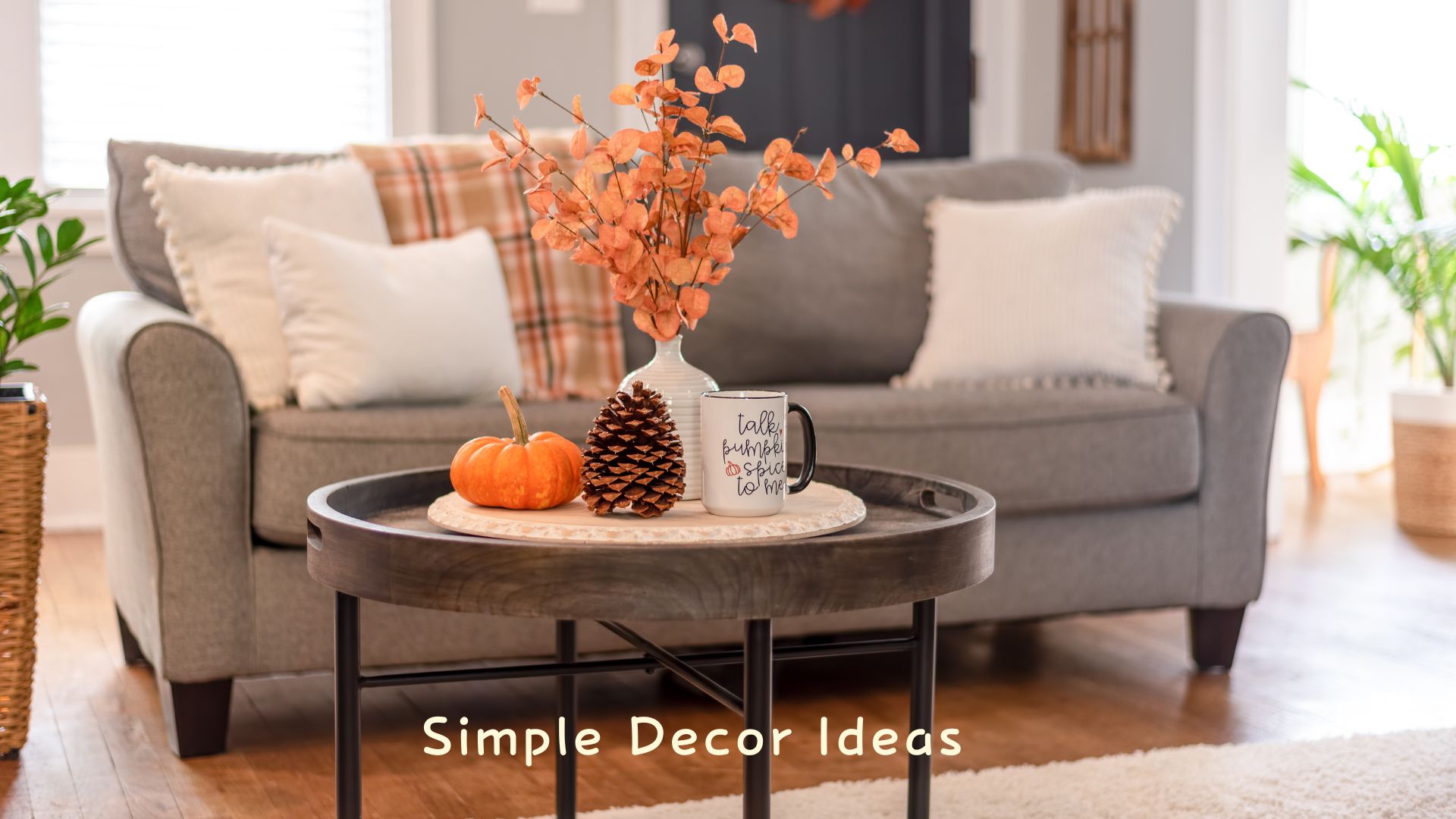 Warm fall living room with soft blankets, autumn pillows, and pumpkins to make your home feel cozy